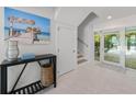 Bright foyer featuring tiled floors, stairs, and backyard views at 870 N Shore Dr, Anna Maria, FL 34216