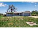 Charming single-story home with a two-car garage, a well-kept lawn, and mature landscaping at 927 Lemon Bay Dr, Venice, FL 34293