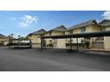 Exterior view of condo buildings with covered parking and well-maintained landscaping at 4234 Gulf Of Mexico Dr # E2, Longboat Key, FL 34228