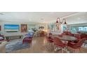 Bright living room with water view, stylish furniture and access to outdoor balcony at 4234 Gulf Of Mexico Dr # E2, Longboat Key, FL 34228