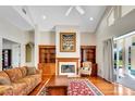 Bright living room with hardwood floors, fireplace, and backyard access at 5750 Saddle Oak Trl, Sarasota, FL 34241