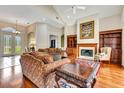 Spacious living room featuring a fireplace, hardwood floors, and vaulted ceilings at 5750 Saddle Oak Trl, Sarasota, FL 34241