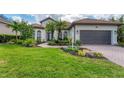 Beautiful home with a tile roof, manicured lawn, and a two-car garage, showcasing great curb appeal at 6832 Bay Hill Dr, Lakewood Ranch, FL 34202