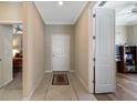 Neutral hallway with tile floor, view of bedroom, and access to study or office at 7108 Playa Bella Dr, Bradenton, FL 34209