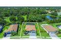 An aerial view of the home showcasing mature trees and a pool; this house includes a screened in lanai at 7323 Great Egret Blvd, Sarasota, FL 34241