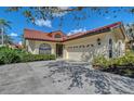 Charming single Gathering home featuring a barrel tile roof and an attached two car garage at 7344 Villa D Este Dr, Sarasota, FL 34238