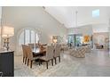 Bright and airy living room featuring high ceilings, tile floors, and a formal dining area at 7344 Villa D Este Dr, Sarasota, FL 34238