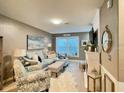 Comfortable living room with stylish furniture, neutral colors, and lots of natural light at 8811 White Sage Loop # 8811, Lakewood Ranch, FL 34202