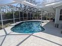 Inviting screened-in pool area features a sparkling blue pool and a spacious patio for outdoor relaxation at 2052 Ivy W Pl, Sarasota, FL 34235