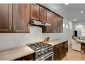 Stainless steel gas range and dark wood cabinetry in modern kitchen at 214 S Westland Ave # 1, Tampa, FL 33606