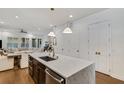 Kitchen island with marble countertop, sink, and breakfast bar at 214 S Westland Ave # 1, Tampa, FL 33606