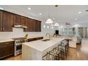 Modern kitchen with dark wood cabinets, marble island, and stainless steel appliances at 214 S Westland Ave # 1, Tampa, FL 33606