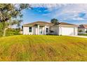 House on a grassy lot with a driveway and garage at 1309 Nackman Rd, North Port, FL 34288