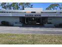 Raleigh House building entrance with covered parking and landscaping at 21280 Brinson Ave # 205, Port Charlotte, FL 33952