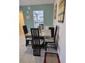 Bright dining area with table and chairs, offering a view of the kitchen at 21280 Brinson Ave # 205, Port Charlotte, FL 33952