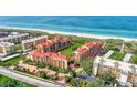 Aerial view showing condo community near the ocean with resort-style amenities at 8750 Midnight Pass Rd # 202, Sarasota, FL 34242