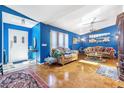 Spacious living room with hardwood floors and blue walls at 2132 Abscott St, Port Charlotte, FL 33952