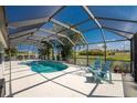 Enclosed pool area with patio furniture and a view at 16446 Belo Ct, Punta Gorda, FL 33955