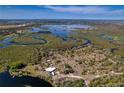 Aerial view showing home on a secluded waterfront lot with lush vegetation at 32091 Serene Dr, Punta Gorda, FL 33982