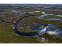 An aerial view of a property situated on a tranquil waterway in a natural setting at 32091 Serene Dr, Punta Gorda, FL 33982