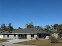 Single-story home features a gray exterior, driveway, and mature landscaping at 17352 Terry Ave, Port Charlotte, FL 33948