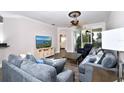 Bright living room with comfy sectional sofa, large TV, and access to balcony at 17258 Acapulco Rd # 122, Punta Gorda, FL 33955