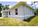 Gray house with vinyl siding, gutters, and a grassy lawn at 2163 Blaser St, Punta Gorda, FL 33980