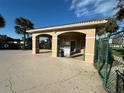 Community pool area with bath house and rules posted at 2736 Suncoast Lakes Blvd, Punta Gorda, FL 33980