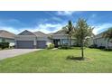 One-story home with gray siding, tile roof, and two-car garage at 15240 Spanish Point Dr, Port Charlotte, FL 33981