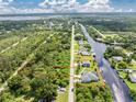 Aerial view of waterfront property with canal access and lush landscaping at 1025 Cheshire St, Port Charlotte, FL 33953