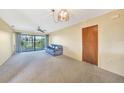 Living room with sliding glass doors, balcony access, and a view at 4260 Placida Rd # 15D, Englewood, FL 34224