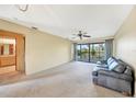 Spacious living room with sliding doors to balcony and view of nature at 4260 Placida Rd # 15D, Englewood, FL 34224