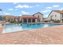 Community pool with clear blue water, lounge chairs, and a covered poolside structure for relaxation at 754 Avenida Estancia # 160, Venice, FL 34292