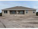 Rear view of one story home with covered patio at 8347 Ada St, Port Charlotte, FL 33981