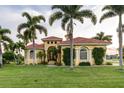 Beautiful home with lush landscaping and palm trees at 24087 Santa Inez Rd, Punta Gorda, FL 33955