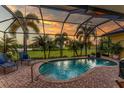 Relaxing pool and patio area with sunset view at 24087 Santa Inez Rd, Punta Gorda, FL 33955