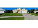 Exterior of a single-story home with a two-car garage and neatly landscaped front yard at 552 Rose Apple Cir, Port Charlotte, FL 33954