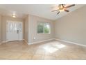 Bright living room with tile floors and a ceiling fan at 2931 S Cranberry Blvd, North Port, FL 34286