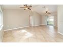 Open living space with tile floors and multiple ceiling fans at 2931 S Cranberry Blvd, North Port, FL 34286