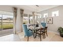 Bright dining room with glass table and seating for six, overlooking the backyard at 16130 Highgate St, Port Charlotte, FL 33953