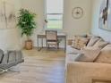 Comfortable seating area with a cozy couch, desk and chair, and decorative wall art at 3140 Sweet Gum Dr, Punta Gorda, FL 33982
