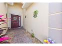 Inviting entryway with brick pavers and a decorated front door at 24723 Rio Villa Lakes Cir, Punta Gorda, FL 33950