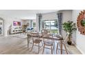 Charming dining room with rustic table and chairs, overlooking a lake at 1051 Adalia Ter, Port Charlotte, FL 33953
