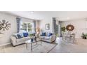Bright living room with comfy sofas, coffee table, and large window at 1051 Adalia Ter, Port Charlotte, FL 33953