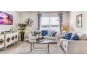 Living room features a large window, comfy sofas, and stylish decor at 1051 Adalia Ter, Port Charlotte, FL 33953
