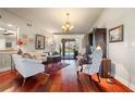 Living room with hardwood floors, comfortable seating, and pool view at 240 Divinci Dr, Punta Gorda, FL 33950