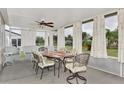 Bright screened porch featuring patio furniture and ceiling fans at 4555 Mckibben Dr, North Port, FL 34287