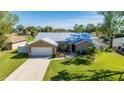 Single-story house with a metal roof, driveway, and yard at 86 Zenith St, Port Charlotte, FL 33954