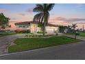 Single-Gathering home with landscaped yard and two-car garage at dusk at 3736 Bal Harbor Blvd, Punta Gorda, FL 33950