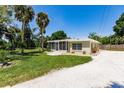 Single story home with grassy yard and gravel driveway at 2112 Mark Ave, Punta Gorda, FL 33950